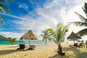 Vacation time background of two beach lounge chairs under grass