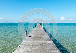 Vacation Time Concept, Wooden Path Between Crystal Clear Blue Sea and Sky from Beach of Island to The Pier in Thailand