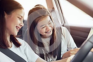 Vacation time and travel, beautiful young women cheerful travels together for a relaxing holiday. And the laughter in the car.