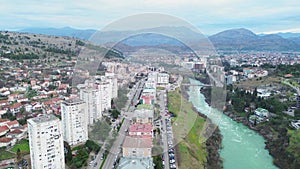 Vacation and travel concept. Aerial view of a small town in the mountains, on the river bank. Podgorica, Montenegro