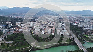 Vacation and travel concept. Aerial view of a small town in the mountains, on the river bank. Podgorica, Montenegro