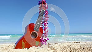 Vacation travel concept with ukulele and lei on tropical beach Oahu Hawaii