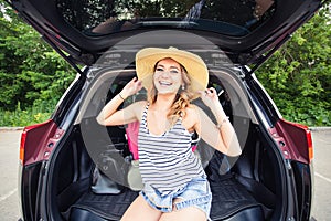 Vacation, Travel concept - young woman ready for the journey on summer holidays with suitcases and car