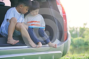 Vacation, Travel - family ready for the travel for summer vacation. Suitcases and car with sea on background. Boy with map in hand