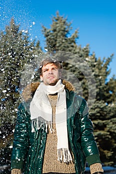 Vacation and traveling in winter. Snowy weather. Trendy winter coat. Man. It is cold outside. Forest in snow. Fresh air