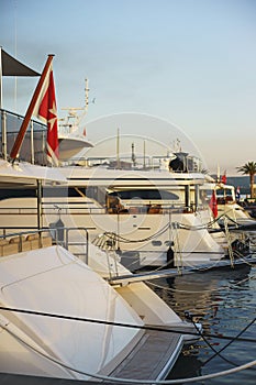 Vacation wallpaper with sea and yachts. Luxury sea expensive multi-deck yacht moored on the pier.