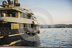 Vacation wallpaper with sea and yachts. Luxury sea expensive multi-deck yacht moored on the pier.