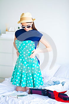 Vacation. Woman Who is Preparing for Rest. Young Beautiful Girl Sits on the Bed. Portrait of a Smiling Woman. Happy Girl
