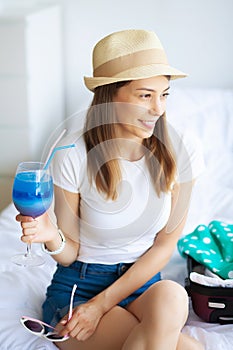 Vacation. Woman Who is Preparing for Rest. Young Beautiful Girl Sits on the Bed. Portrait of a Smiling Woman. Happy Girl