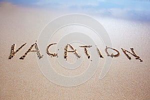 Vacation written on beach