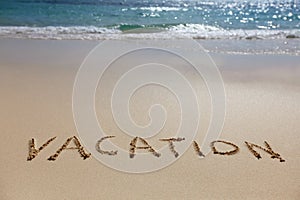 Vacation written on beach