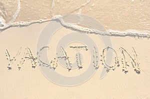Vacation Written in Sand on Beach