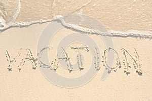 Vacation Written in Sand on Beach