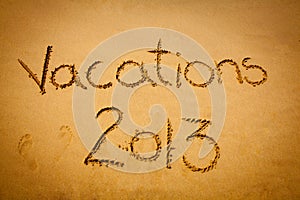 Vacations 2013 written on sand - on the beach