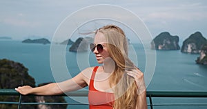 Vacations in Krabi, Thailand, young woman relaxing at viewpoint, enjoying island