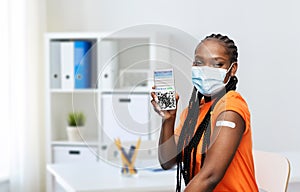 vaccinated woman in mask showing qr code on phone