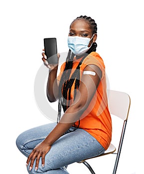 vaccinated woman in mask with smartphone