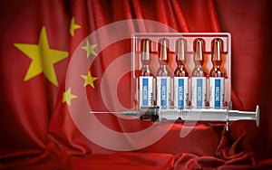 Vaccination in China concept. Syrringe and vials with vaccine on chinese flag