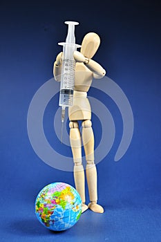 Vaccination concept with syringe and planet Earth