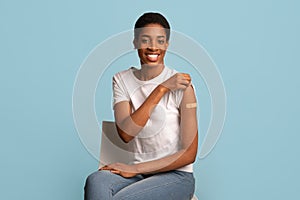 After Vaccination Concept. Vaccinated Black Woman Showing Arm After Coronavirus Vaccine Injection