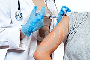 Vaccination. Doctor injecting flu vaccine to patient`s arm.