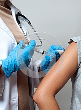 Vaccination. Doctor injecting flu vaccine to patient`s arm.