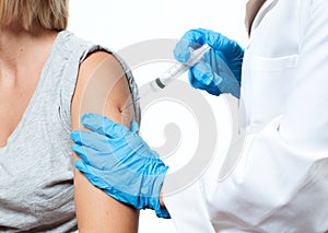 Vaccination. Doctor injecting flu vaccine to patient`s arm.