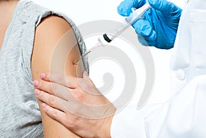 Vaccination. Doctor injecting flu vaccine to patient`s arm.