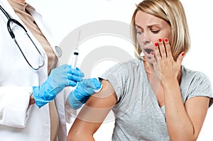 Vaccination. Doctor with syringe making vaccination to patient