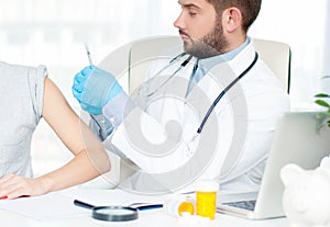 Vaccination. Flu shot. Doctor injecting flu vaccine to patient`s arm