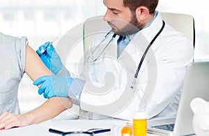 Vaccination. Flu shot. Doctor injecting flu vaccine to patient`s arm