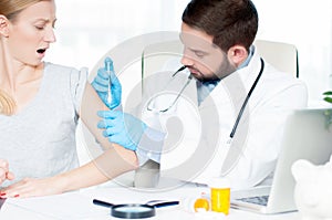 Vaccination. Flu shot. Doctor injecting flu vaccine to patient`s arm