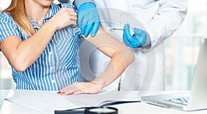 Vaccination. Flu shot. Doctor injecting flu vaccine to patient`s arm