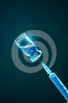 Vaccination and healthcare. Ampoule with blue vaccine medicine, syringe filling up from glass vial in neon studio light
