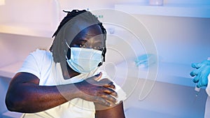 Vaccination and immunization with mRNA vaccine against coronavirus. Young african american black man with face mask