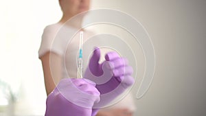 Vaccination of a pregnant woman. Doctor in gloves puts vaccine. Covid vaccination concept