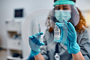 Vaccination and preservation and protection of health. A female doctor in a protective mask and protective medical gloves holds a