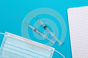 Vaccination or Revaccination Concept - Three Insulin Syringe on Blue Table
