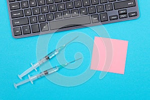 Vaccination or Revaccination Concept - Two Medical Syringe on Blue Table