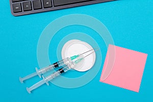 Vaccination or Revaccination Concept - Two Medical Syringe on Blue Table