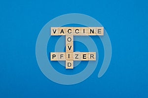 Vaccine 90% effective against the coronavirus pandemic written with wooden letters on a blue background. Covid concept
