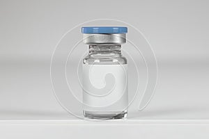 Vaccine bottle isolated on a neutral background photo