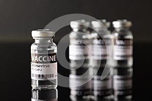 Vaccine covid-19 in black background photo