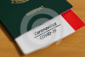 Vaccine Passport Concept. COVID-19 vaccination proof on a card tucked inside the passport