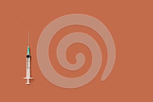 Vaccine syringe isolated on orange background. copyspace