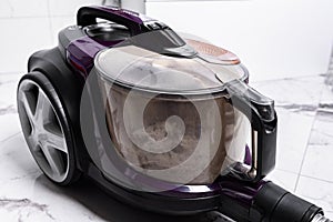 Vacuum cleaner full of garbage after home cleaning.