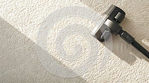 Vacuum cleaner head gliding over fluffy white rug. Carpet cleaning. Vacuuming. Concept of home cleanliness, dust