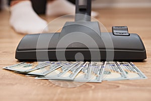 Vacuum cleaner suck usd dollar banknotes. Launder money concept