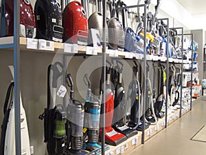 Vacuum cleaners or hoovers for sale in a store.