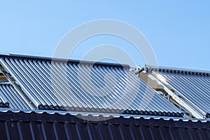 Vacuum solar water heating system on the house roof.